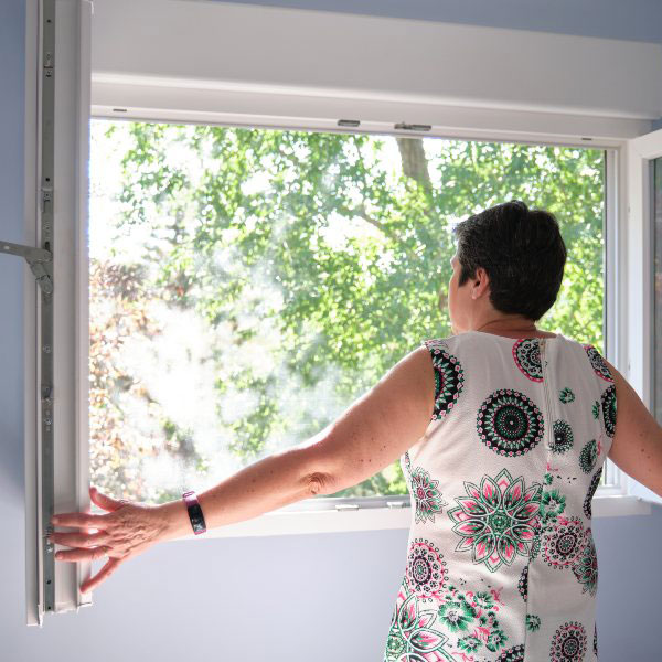 Woman opening the window to take a breath
